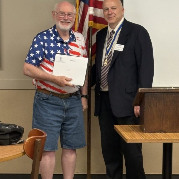 June 2026 - K. Thomas receives membership certificates for son and grandson